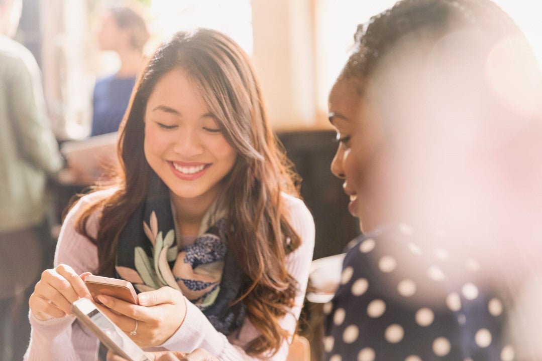 women smiling and talking with phone