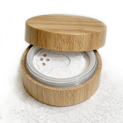 Bamboo container with a titanium dioxide free white mineral veil finishing powder on a white background